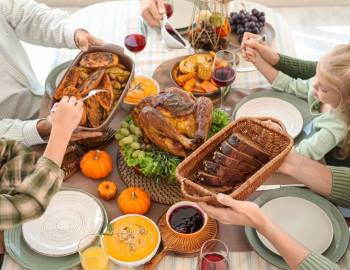 A family enjoying Thanksgiving dinner at a vacation rental on Hilton Head Island